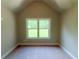 Attic space with neutral paint, carpet flooring and natural light entering through the window at 125 Honey Creek Rd, Conyers, GA 30094