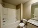 Well-lit bathroom featuring a shower-tub combination and stylish vanity with granite countertop at 125 Honey Creek Rd, Conyers, GA 30094