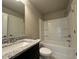 Modern bathroom with granite countertops, bathtub and shower combo at 125 Honey Creek Rd, Conyers, GA 30094