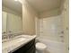 Bathroom featuring a bathtub/shower combo and vanity with granite countertop and tile flooring at 125 Honey Creek Rd, Conyers, GA 30094