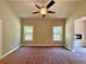 Cozy bedroom with two large windows, neutral walls, and a ceiling fan at 125 Honey Creek Rd, Conyers, GA 30094