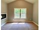 Serene bedroom with a fireplace, and a large window overlooking nature at 125 Honey Creek Rd, Conyers, GA 30094