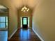 Bright foyer featuring hardwood floors, a modern chandelier, and a view of the front door with sidelights at 125 Honey Creek Rd, Conyers, GA 30094