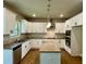 Bright kitchen featuring white cabinets, stone countertops, a center island, and stainless steel appliances at 125 Honey Creek Rd, Conyers, GA 30094