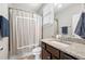 Cozy bathroom featuring a framed shower curtain, granite countertop, and under sink cabinet at 174 Kelly St, Norcross, GA 30071