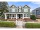 Charming two-story home with a welcoming front porch and white picket fence at 174 Kelly St, Norcross, GA 30071