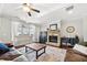 Spacious living room with a stone fireplace, ceiling fan, and large windows at 174 Kelly St, Norcross, GA 30071