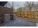 View of a backyard space with rock features, wood fence, and central air units at 2323 Mason Dr # D21, Atlanta, GA 30316