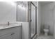 Modern bathroom featuring a patterned accent wall, frameless shower, marble floors, and a sleek vanity at 2323 Mason Dr # D21, Atlanta, GA 30316