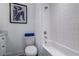 A bright bathroom has tile walls, tub and shower, along with toilet and towel at 2323 Mason Dr # D21, Atlanta, GA 30316