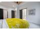 Bedroom with white walls, gray carpet, ceiling fan, and barn door access to a stylish bathroom at 2323 Mason Dr # D21, Atlanta, GA 30316