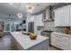 Bright kitchen featuring an island with quartz countertop, stainless steel appliances, and modern decorative lighting at 2323 Mason Dr # D21, Atlanta, GA 30316