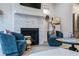 Stylish living room featuring a stone fireplace and comfortable blue armchairs at 2323 Mason Dr # D21, Atlanta, GA 30316