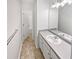 Bathroom featuring a single sink vanity, a large mirror, and a view into the toilet and shower area at 545 Zoie Ln, Palmetto, GA 30268