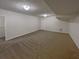 Basement area with neutral walls and carpet, and overhead lighting at 1750 Elizabeth Sw Ct, Conyers, GA 30094