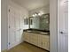 Elegant bathroom featuring a double vanity, granite countertop and an oversized mirror, complemented by modern fixtures at 1750 Elizabeth Sw Ct, Conyers, GA 30094