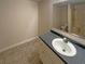 Bathroom with single sink, vanity, and tiled walk-in shower at 1750 Elizabeth Sw Ct, Conyers, GA 30094