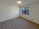 Bedroom with neutral carpet, baseboard trim, and view from the window at 1750 Elizabeth Sw Ct, Conyers, GA 30094
