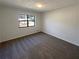 This bedroom features neutral walls and carpet, a large window for natural light, creating a blank canvas for personalization at 1750 Elizabeth Sw Ct, Conyers, GA 30094