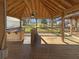 Covered wooden deck features custom bar and backyard view at 1750 Elizabeth Sw Ct, Conyers, GA 30094