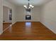 Open dining room featuring wood floors, large windows, and elegant chandelier at 1750 Elizabeth Sw Ct, Conyers, GA 30094