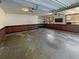 Spacious garage with brick accents, storage shelves, and natural lighting at 1750 Elizabeth Sw Ct, Conyers, GA 30094