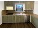 Traditional kitchen featuring matching olive cabinets, stainless steel sink, and granite countertops at 1750 Elizabeth Sw Ct, Conyers, GA 30094