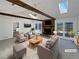 Bright, airy living room with vaulted ceilings, exposed beams, stone fireplace and access to outdoor deck, perfect for entertaining at 1750 Elizabeth Sw Ct, Conyers, GA 30094