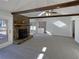 Spacious living room featuring wood beams, fireplace, access to the outdoor deck and large open space for entertaining at 1750 Elizabeth Sw Ct, Conyers, GA 30094