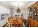 Classic dining room features hardwood floors, crown molding, a chandelier, and a hutch displaying glassware at 183 Gatlin Ridge Run, Dallas, GA 30157