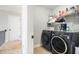 Laundry room featuring washer and dryer with overhead storage at 183 Gatlin Ridge Run, Dallas, GA 30157