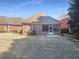 Brick backyard with a screened-in porch and small yard area at 1832 Glenwood Ln, Snellville, GA 30078
