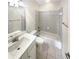 Clean bathroom features a tub with shower and a white vanity at 1832 Glenwood Ln, Snellville, GA 30078