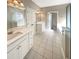 Elegant bathroom with double vanities, white cabinets, tile flooring, and a bright, open design at 1832 Glenwood Ln, Snellville, GA 30078