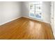 Bright bedroom featuring hardwood floors and a large window at 1832 Glenwood Ln, Snellville, GA 30078