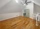 Bright bonus room with hardwood floors, ceiling fan, and adjacent bathroom entrance at 1832 Glenwood Ln, Snellville, GA 30078