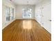 Bright dining room features hardwood floors, large windows, and modern lighting for elegant entertaining at 1832 Glenwood Ln, Snellville, GA 30078