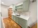 Charming kitchen with custom cabinets, open shelves, tile backsplash, and hardwood flooring at 1832 Glenwood Ln, Snellville, GA 30078