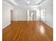 Spacious main bedroom features hardwood floors, tray ceiling, and double doors to an ensuite bath at 1832 Glenwood Ln, Snellville, GA 30078