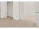 Bright bedroom features neutral carpeting, white walls, closet with shelving, and two entry doors at 464 Reflection Dr # 22, Stockbridge, GA 30281