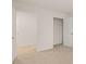Bright bedroom features neutral carpeting, white walls, closet with shelving, and two entry doors at 464 Reflection Dr # 22, Stockbridge, GA 30281