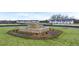 View of the community landscaping area featuring stone water feature and greenery between townhome units at 464 Reflection Dr # 22, Stockbridge, GA 30281