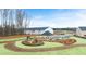 View of community playground, picnic shelter, townhome exteriors, and parking area, surrounded by a lawn at 464 Reflection Dr # 22, Stockbridge, GA 30281