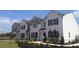 New townhomes with painted brick and siding, black shutters, and dark roofs situated in a landscaped area at 464 Reflection Dr # 22, Stockbridge, GA 30281