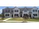 Charming new townhomes featuring painted brick, contrasting trim, black shutters, and well-manicured lawns at 464 Reflection Dr # 22, Stockbridge, GA 30281