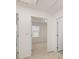 Hallway featuring open doors leading to different rooms, carpeted flooring, and white trim at 464 Reflection Dr # 22, Stockbridge, GA 30281