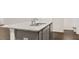 Close-up shot of kitchen island with granite countertop, sink, and grey cabinetry at 464 Reflection Dr # 22, Stockbridge, GA 30281
