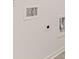 Close-up of laundry room wall with white trim, washer and dryer hookups, and baseboards at 464 Reflection Dr # 22, Stockbridge, GA 30281