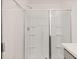 Walk-in shower features built-in shelving and a sleek, modern design with glass doors at 464 Reflection Dr # 22, Stockbridge, GA 30281
