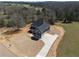 Beautiful two-story home with dark gray siding, a concrete driveway, and a well-manicured lawn at 115 River Meadow Ln, Social Circle, GA 30025